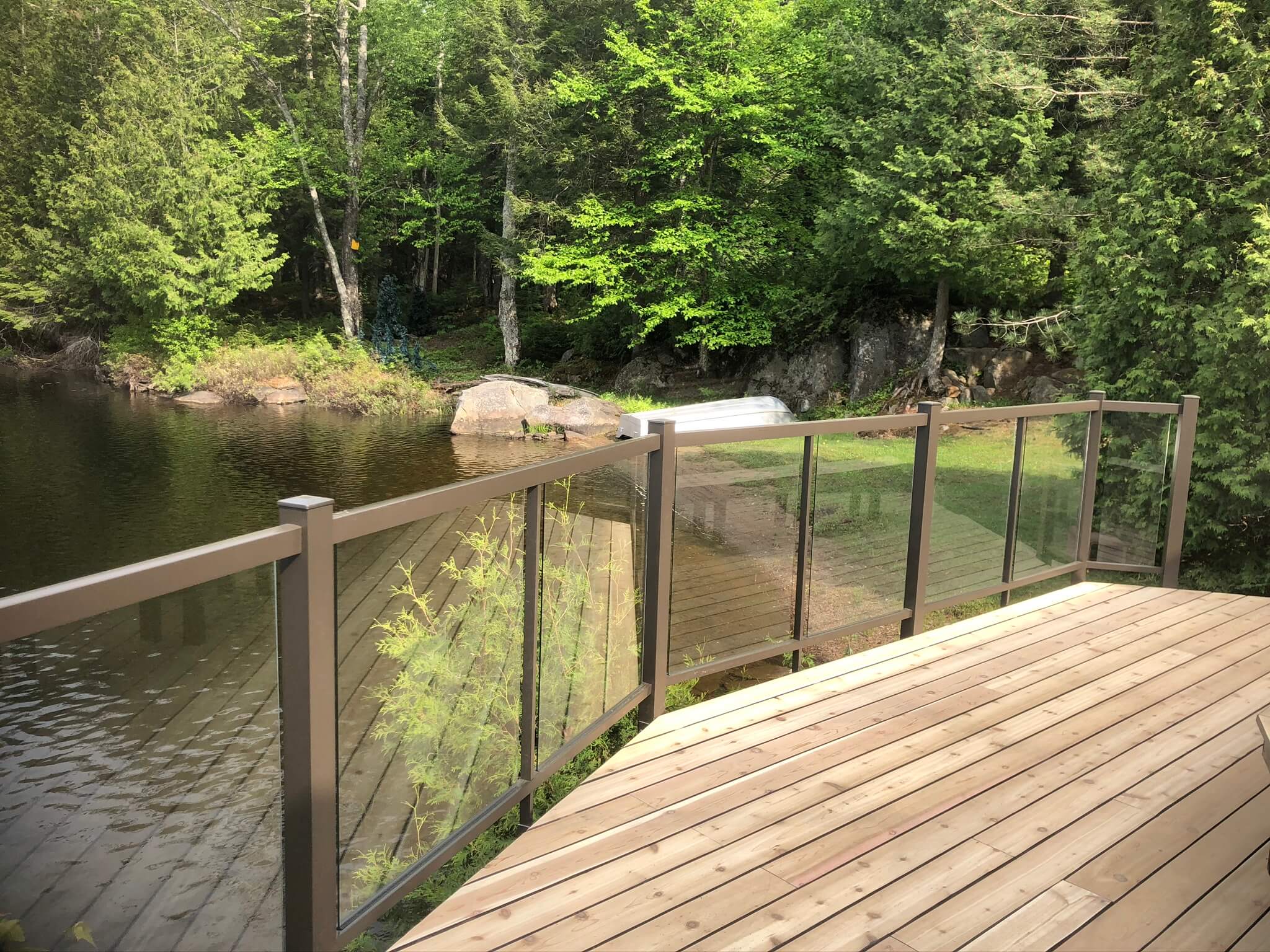 deck with glass railing lake