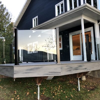 Exterior glass railing with door in Saint-Donat