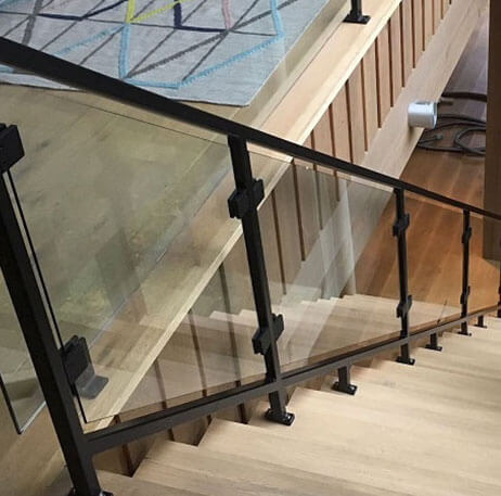 glass indoor railing with black steel frame